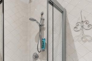 a shower with a glass door in a bathroom at Affittacamere Borgo Trento in Verona