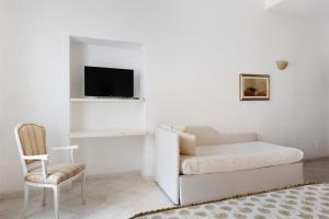 a white living room with a couch and a chair at Affittacamere Borgo Trento in Verona