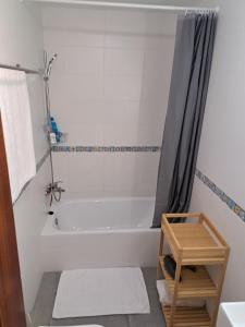 a bathroom with a white tub and a shower at Casa de Manuel in Pinos Genil