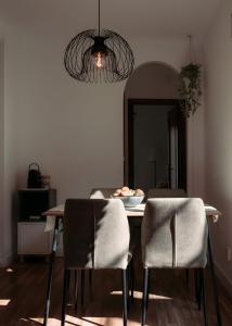 a dining room table with chairs and a plate of food on it at Casa de Manuel in Pinos Genil