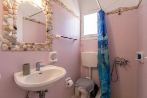 a bathroom with a sink and a mirror at Green Retreats 5 Paros in Isterni