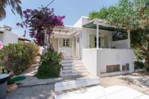 a white house with stairs leading to it at Green Retreats 5 Paros in Isterni