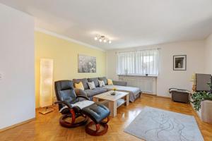 a living room with a couch and a table at Ferienwohnung Lemke in Donaueschingen +26 photos