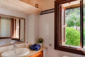 a bathroom with a sink and a window at Finca Estrella in Artá +15 photos