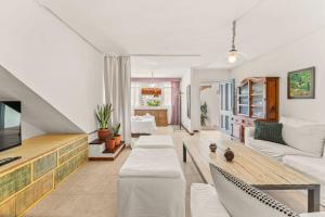 a living room with a couch and a tv at Apartamento Cipreses in Puerto del Carmen