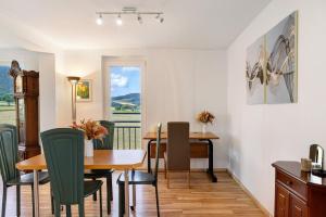 a dining room with a table and chairs and a window at Haus Lerchenweg in Bad Wildungen