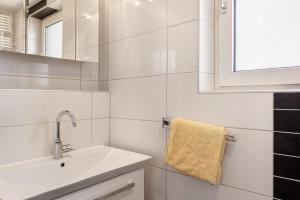 a white bathroom with a sink and a mirror at Haus Lerchenweg in Bad Wildungen +19 photos