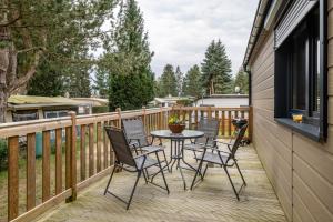 a patio with a table and chairs on a deck at Haus Zander in Lohmen