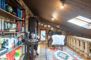 a room with a chair and books on shelves at Casa Da Puza in Forcarei