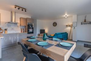 a kitchen and dining room with a table and chairs at La p'tite maison de Charlotte in Cissac-Médoc