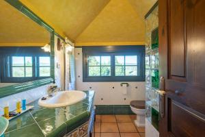 a bathroom with a sink and a toilet at Casa Da Puza in Forcarei +23 photos