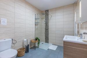 a bathroom with a shower and a toilet and a sink at La p'tite maison de Charlotte in Cissac-Médoc +20 photos