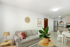 a white living room with a couch and a table at Sunrise Arinaga in Arinaga +19 photos