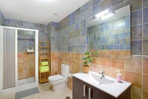 a bathroom with a toilet and a sink at Sunrise Arinaga in Arinaga