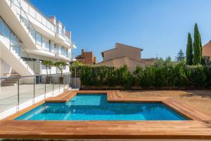 a swimming pool in the backyard of a house at Ático Las Palmeras in Cala Millor