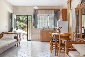a kitchen and dining room with a table and chairs at Daratos apartment 3 in Kefallonia