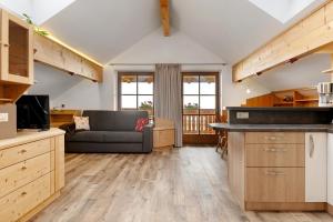 a kitchen and living room with a couch and a table at Kardinerhof in Collalbo