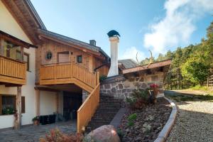 a house with a staircase leading up to a building at Kardinerhof in Collalbo