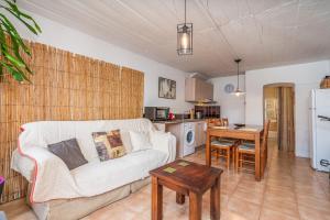 a living room with a couch and a table at Casa da Praia 2 in Budens