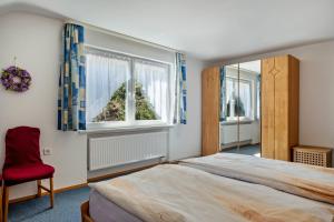 a bedroom with a large bed and a window at Unterfalkenhof in Schramberg
