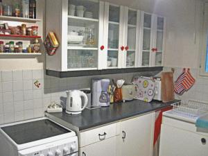 a kitchen with white cabinets and a stove top oven at Haus Zypresse in Saint-Saturnin-lès-Apt