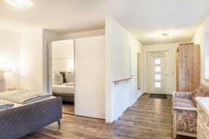 a room with a bed and a bedroom with a bed and a bed at Ferienwohnung Zugspitze in Ehrwald