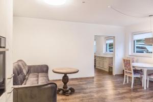 a living room with a couch and a table at Ferienwohnung Zugspitze in Ehrwald +15 photos