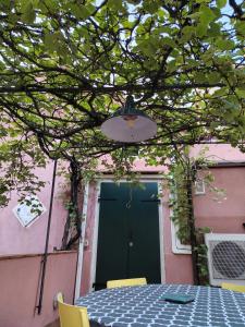 a table with yellow chairs and a green door at DolceVita Apartments N 241 in Venice