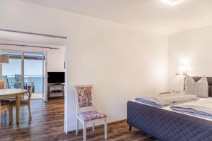a bedroom with a bed and a dining room at Ferienwohnung Zugspitze in Ehrwald