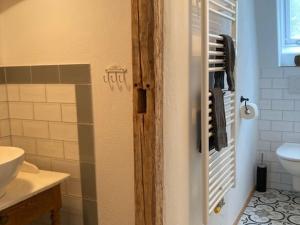 a bathroom with a toilet and a sink at Ferienwohnung Rahel in Münsingen