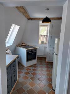 a small kitchen with a stove and a refrigerator at Ferienwohnung Rahel in Münsingen