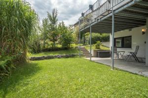 a house with a green lawn in the yard at Casa Rindler in Sigmarszell