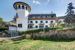 a building with a lighthouse on top of a hill at Appartamento Bilocale Moneglia 21 in Moneglia
