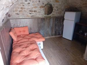 a small bedroom with a bed and a refrigerator at Glamping C Selva Tenda Ciliegio in Piano Porlezza