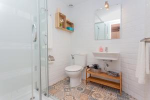 a bathroom with a toilet and a sink and a shower at Villa Seve in Cala en Bosc +17 photos