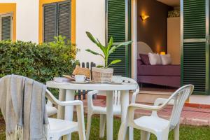a white table and chairs on a patio at Villa Seve in Cala en Bosc
