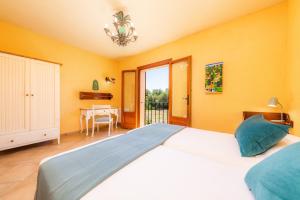a bedroom with a large bed and a dining room at Finca Ca'n Terrasa in Capdepera +19 photos