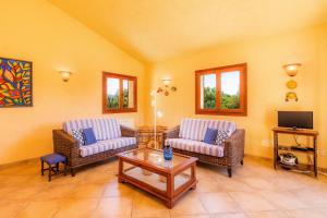 a living room with two couches and a coffee table at Finca Ca'n Terrasa in Capdepera