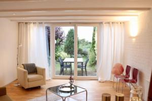 a living room with a table and chairs and a large window at Tiny Haus an der Schlei in Kosel