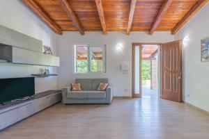 a large living room with a couch and a tv at Villa Lorenzo in Avola