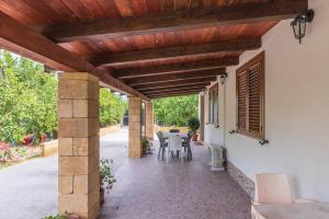 an outdoor patio with a wooden pergola at Villa Lorenzo in Avola