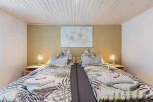 two beds in a room with towels on them at Ferienwohnung Schmidt in Wehr