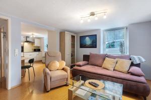 a living room with a couch and a table at Ferienwohnung Schmidt in Wehr