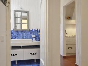 a bathroom with a white sink and a mirror at Casa 23 in Castiadas
