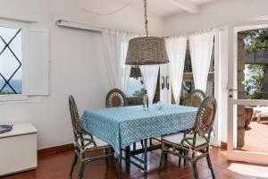 a dining room with a blue table and chairs at Casa 23 in Castiadas +27 photos