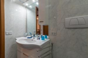 a white bathroom with a sink and a mirror at Casaentino in Capolona +14 photos