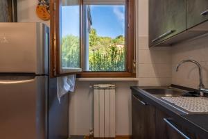 a kitchen with a sink and a window at Casaentino in Capolona