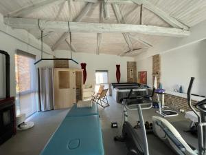 a room with a gym with exercise equipment in it at Cascina Solaro in Asti