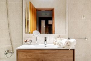 a bathroom with a sink and a mirror at Lagoa Residence in Esposende