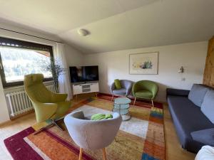 a living room with a couch and chairs at Fewo 1 am Auweg in Hirschegg